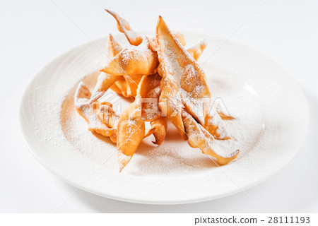 Sweet thin crispy cookies "Brushwood" deep fried topped with powdered sugar Sweet thin crispy cookies "Brushwood" deep fried topped with powdered sugar 28111193