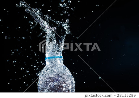Water splashes from the bottle on black background 28113289