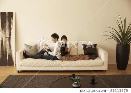 Tower apartment couple relaxing on the sofa Tower apartment couple relaxing on the sofa 28115376