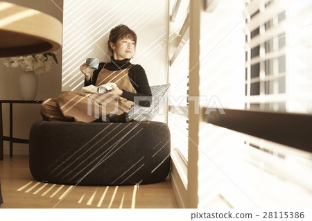 Tower apartment Woman relaxing at the window 28115386