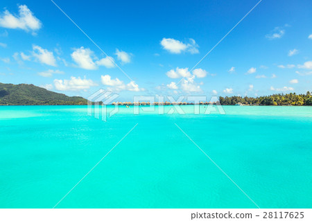 View of blue turquoise lagoon and far bungalows  28117625