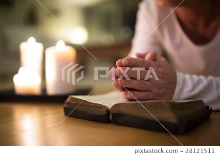 Unrecognizable senior woman praying, hands clasped Unrecognizable senior woman praying, hands clasped 28121511
