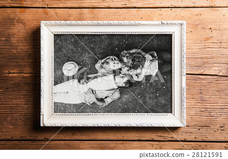 Photo of seniors in picture frame laid on wooden Photo of seniors in picture frame laid on wooden 28121591