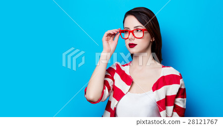 portrait of the beautiful young smiling woman on the blue backgr 28121767