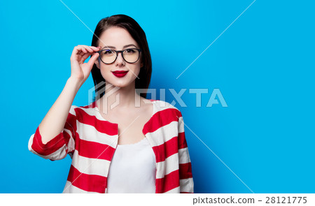 portrait of the beautiful young smiling woman on the blue backgr 28121775