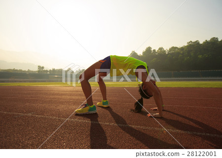 young asian woman backbending on stadium track young asian woman backbending on stadium track 28122001