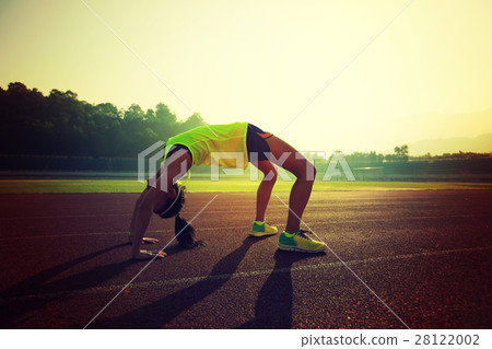 young asian woman backbending on stadium track young asian woman backbending on stadium track 28122002