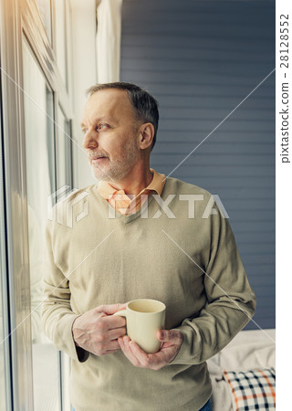 Happy male pensioner relaxing at home 28128552