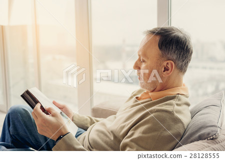 Wise male pensioner entertaining with literature Wise male pensioner entertaining with literature 28128555