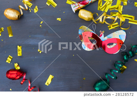 Masquerade decorations on dark wooden background Masquerade decorations on dark wooden background 28128572