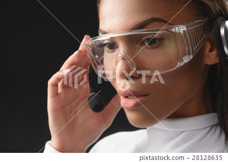 Thoughtful african woman working with headset 28128635