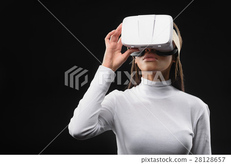 Curious mulatto girl using vr headset 28128657