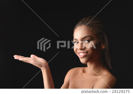 Happy african woman showing something interesting 28129275