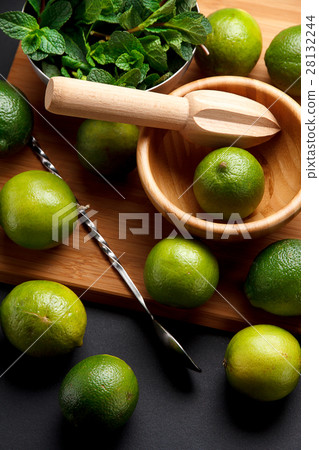 Lime is ready for juicing on a black table Lime is ready for juicing on a black table 28132244