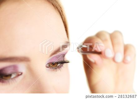 Woman tweezing eyebrows plucking with tweezers 28132687