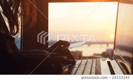 Woman using credit card online with her laptop on 28133245
