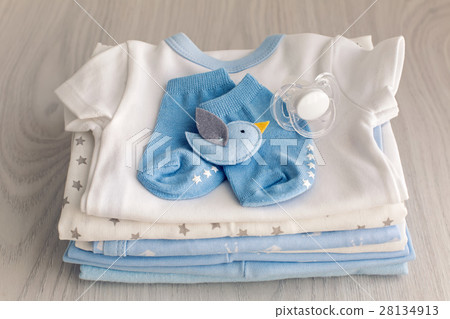 children's clothes with the diapers are stacked 28134913