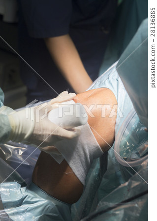 Knee surgery nurse bandaging Knee surgery nurse bandaging 28136885