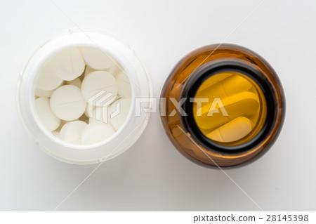 Top view of two bottles of different pills 28145398