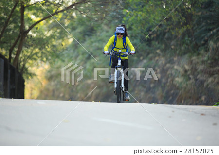 woman cyclist riding mountain bike on forest trail 28152025