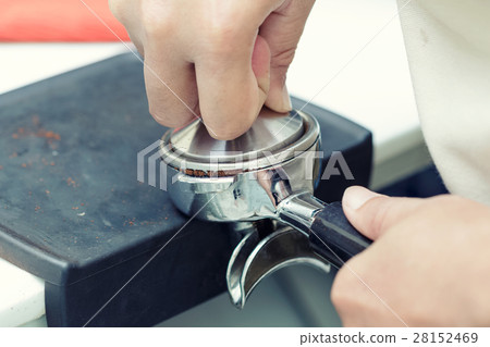 Hands of professional barista supplying coffee Hands of professional barista supplying coffee 28152469