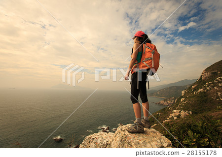 successful hiker hiking on seaside mountain peak successful hiker hiking on seaside mountain peak 28155178