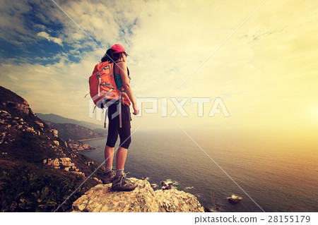 successful hiker hiking on seaside mountain peak successful hiker hiking on seaside mountain peak 28155179