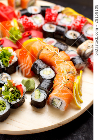 Sushi set on a wooden plate and black concrete Sushi set on a wooden plate and black concrete 28159109