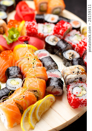 Sushi set on a wooden plate and black concrete  28159111