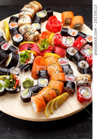 Sushi set on a wooden plate and black concrete Sushi set on a wooden plate and black concrete 28159113