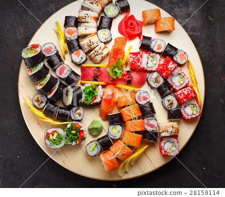 Sushi set on a wooden plate and black concrete Sushi set on a wooden plate and black concrete 28159114