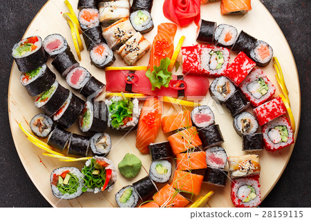 Sushi set on a wooden plate and black concrete Sushi set on a wooden plate and black concrete 28159115