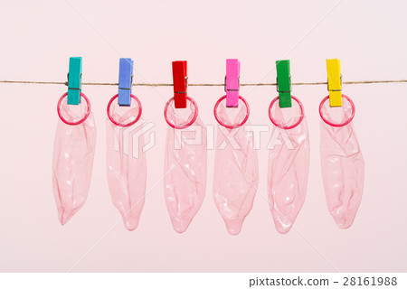 Unrolled latex condoms on white background Unrolled latex condoms on white background 28161988
