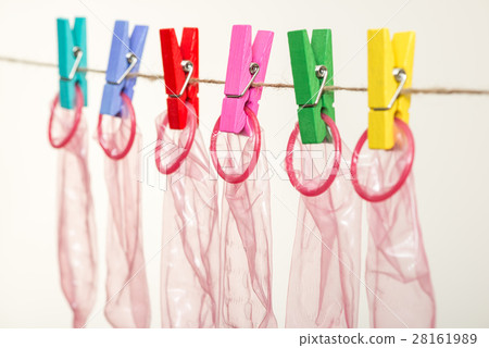 Unrolled latex condoms on white background Unrolled latex condoms on white background 28161989
