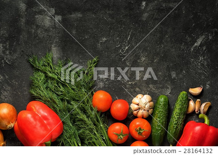 Raw vegetables on a dark black stone background 28164132