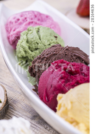 A ball of chocolate ice cream among other multi-co A ball of chocolate ice cream among other multi-co 28164636