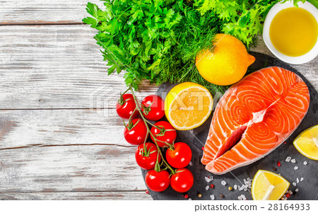 portion of fresh salmon steak with aromatic herbs 28164933