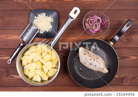 Wooden spoon and ingredients on dark background Wooden spoon and ingredients on dark background 28164956