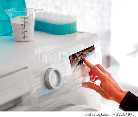 woman choosing program for washing woman choosing program for washing 28164973