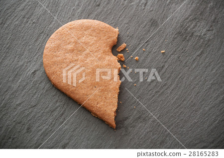 shaped broken heart biscuit on chalkboard shaped broken heart biscuit on chalkboard 28165283