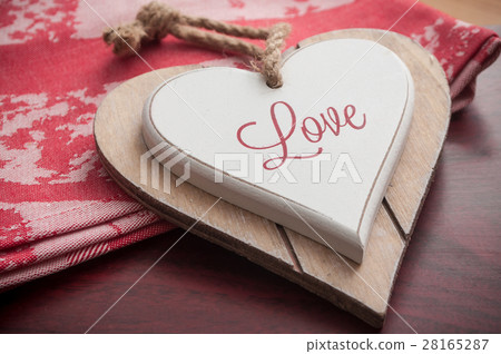 wooden heart on the red tablecloth wooden heart on the red tablecloth 28165287