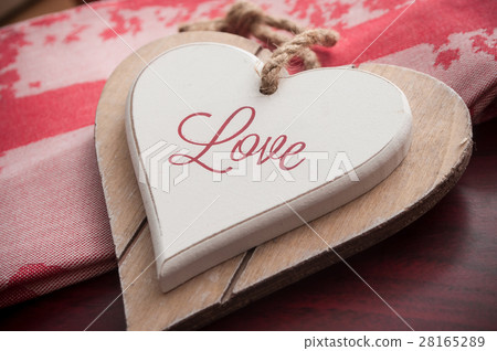 wooden heart on the red tablecloth wooden heart on the red tablecloth 28165289