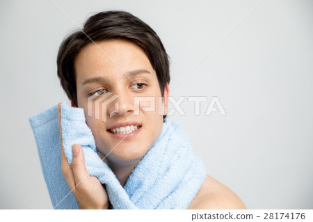 man wiping face with towel man wiping face with towel 28174176