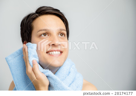 man wiping face with towel man wiping face with towel 28174177