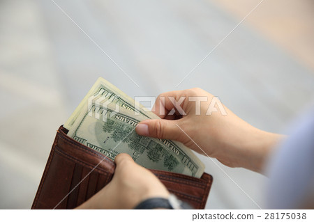 Hands taking out money from wallet on street 28175038