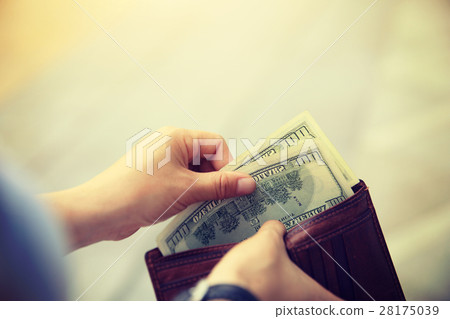 Hands taking out money from wallet on street 28175039