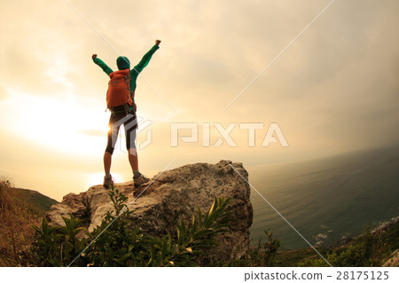successful hiker hiking on seaside mountain peak successful hiker hiking on seaside mountain peak 28175125