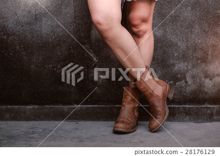 Girl with boots at wall. 28176129