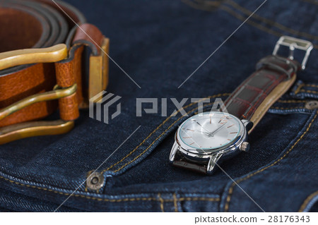 Wrist watch and leather belt on jeans 28176343