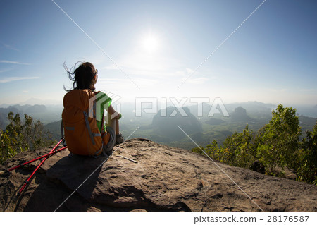 young backpacker sit on the mountain peak rock young backpacker sit on the mountain peak rock 28176587